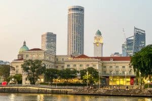 Best Time of Year to Visit Singapore 26 The Asian Civilisations Museum beside the Singapore River, with modern skyscrapers and a historic clock tower in the background at dusk, invites you to explore and Visit Singapore's rich heritage.