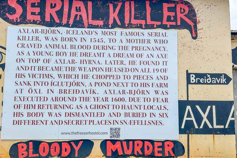 Street Art in Iceland 18 A sign displays information about Axlar-Björn, an Icelandic serial killer from 1545, detailing his crimes, weapon, and execution. The words "SERIAL KILLER" and "BLOODY MURDER" are prominently featured in large red letters.