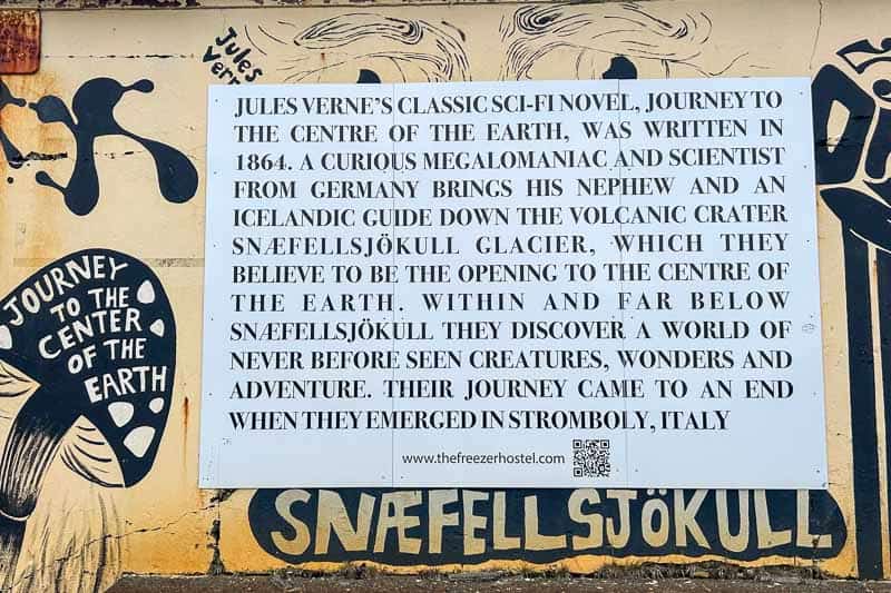Street Art in Iceland 19 A sign on a mural describes Jules Verne’s novel “Journey to the Centre of the Earth.” The text explains the story’s plot involving Snæfellsjökull Glacier and a journey to the Earth’s centre.