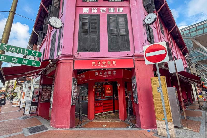 Where to Eat Kaya Toast in Singapore: 9 Places I've Tried 19 A red and pink building on a street corner houses a café called “Nanyang Old Coffee.” Chinese and English signage is visible, with a no entry traffic sign and a street sign reading “Smith St” in the foreground.