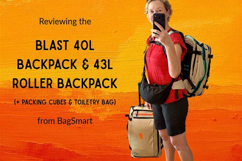 Josie Wanders Gen X Travel 11 A person in a red shirt takes a mirror selfie whilst wearing a large rucksack and holding a wheeled suitcase, with text overlaying the image advertising a BagSmart travel gear review.